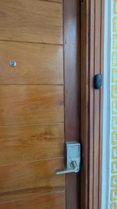 a wooden door with a lock on it at Eva Apparts "situé à Kotto Baden Baden" - PARKING CAMERA BALCON WIFI CLIM CONFORT in Douala