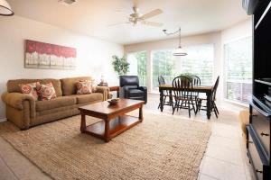 a living room with a couch and a table at WW A302 River Relaxation in New Braunfels
