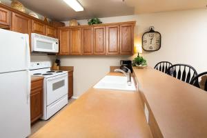 a kitchen with wooden cabinets and a counter top with a sink at WW A302 River Relaxation in New Braunfels +18 photos