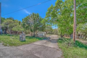 an empty road in a field with trees at CL 2459 Yellow Rose in Canyon Lake