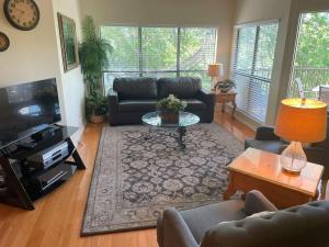 a living room with a couch and a table at IC 216 Inverness Condos Comal River in New Braunfels