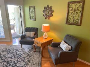 a living room with two chairs and a table with a lamp at IC 216 Inverness Condos Comal River in New Braunfels