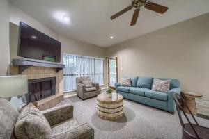 a living room with a blue couch and a fireplace at CW B206 Rivers Edge in New Braunfels