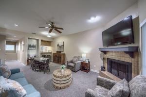 a living room with a fireplace and a flat screen tv at CW B206 Rivers Edge in New Braunfels