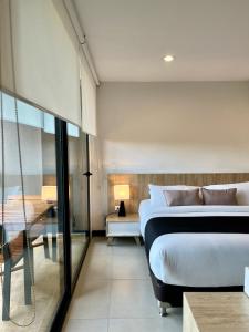 a bedroom with a bed and a view of a bathroom at Rioverde Living suites- Apartahotel in Rionegro +18 photos