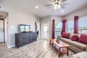 a living room with a couch and a flat screen tv at IC 309 Wine Dine in New Braunfels