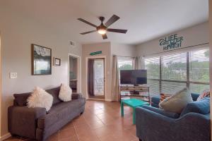 a living room with two couches and a flat screen tv at IC 302 Ripley River Haus in New Braunfels