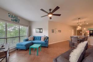 a living room with a blue couch and a ceiling fan at IC 302 Ripley River Haus in New Braunfels