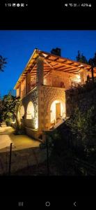 a house with a balcony on top of it at Villa Amalthia Panorama in Bozikás