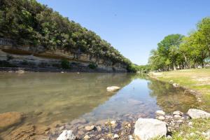 a river with rocks and trees on the side at RG 105 Rio Refuge in Canyon Lake