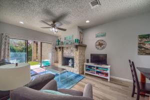 a living room with a couch and a fireplace at CW C107 Spritzen Haus in New Braunfels