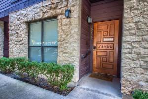 a wooden door on a house with a stone wall at CW C107 Spritzen Haus in New Braunfels