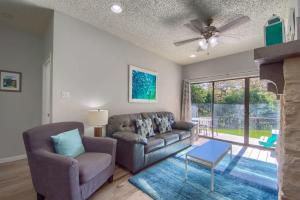 a living room with a couch and a ceiling fan at CW C107 Spritzen Haus in New Braunfels +28 photos
