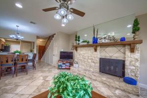 a living room with a fireplace and a dining room at CW C207 River Zen in New Braunfels