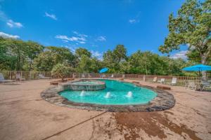 a swimming pool with a fountain in a yard at WW H303 Dreams and Streams in New Braunfels
