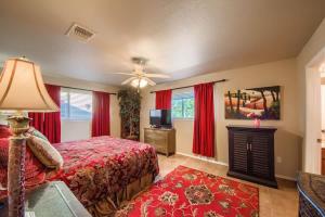 a bedroom with a bed and a tv and red curtains at WW H303 Dreams and Streams in New Braunfels