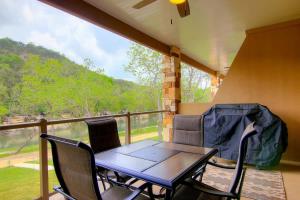 a table and chairs on a balcony with a view at RG 208 Rivendell On The Guadalupe in Canyon Lake +23 photos
