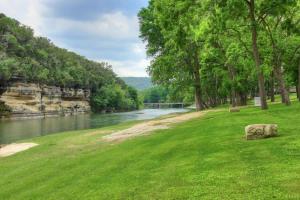 a green field with a river and trees and a bridge at RG 203 Riverview Terrace in Canyon Lake