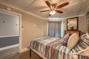 a bedroom with a bed with a ceiling fan at RRC A302 River Hippie in New Braunfels +23 photos