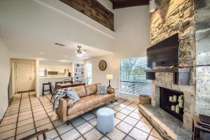 a living room with a couch and a fireplace at TBM 112 Among The Oaks in New Braunfels