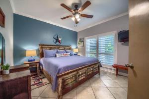 a bedroom with a bed and a ceiling fan at IC 112 Cowboy Corral in New Braunfels