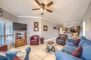 a living room with a blue couch and a ceiling fan at IC 112 Cowboy Corral in New Braunfels