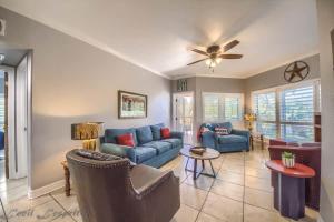 a living room with blue couches and a ceiling fan at IC 112 Cowboy Corral in New Braunfels +19 photos