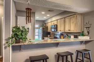a kitchen with a counter with stools in it at CW C104 Fun on the Comal in New Braunfels