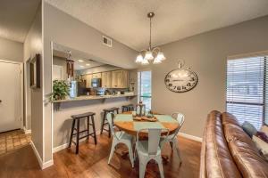 a kitchen and dining room with a table and a couch at CW C104 Fun on the Comal in New Braunfels