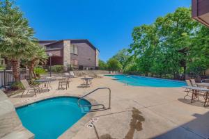 a resort style swimming pool with tables and chairs at CW C104 Fun on the Comal in New Braunfels +31 photos