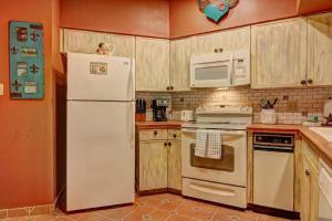a kitchen with a white refrigerator and a microwave at IC 110 Comal Corral in New Braunfels