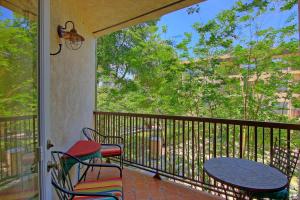 a balcony with a table and chairs and a window at IC 110 Comal Corral in New Braunfels