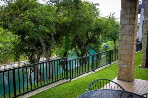 a black fence next to a body of water at CW C109 River Bend in New Braunfels