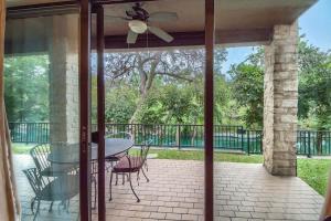 a screened in porch with a table and chairs at CW C109 River Bend in New Braunfels