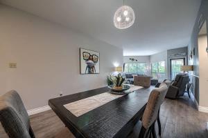 a dining room and living room with a table and chairs at IC 316 Riverfront Bliss in New Braunfels