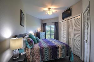 a bedroom with a bed and a lamp and a window at IC 316 Riverfront Bliss in New Braunfels