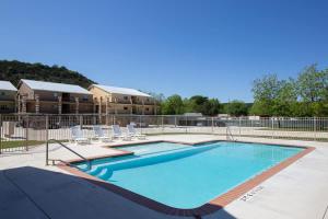 a swimming pool at a resort with chairs at RG 306 Hillside River Retreat in Canyon Lake