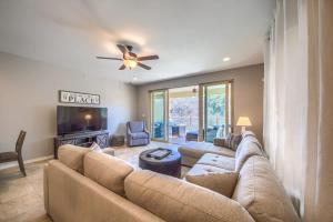a living room with a large couch and a ceiling fan at RG 306 Hillside River Retreat in Canyon Lake
