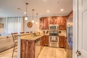 a kitchen with wooden cabinets and a stove top oven at RG 306 Hillside River Retreat in Canyon Lake +17 photos