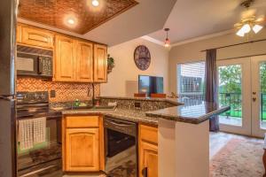 a kitchen with wooden cabinets and a counter top at SS B4 Riverside Condo in New Braunfels