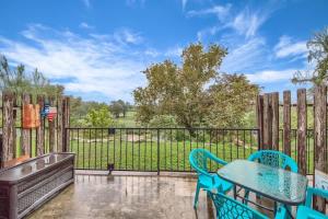 a patio with a table and chairs and a fence at SS B4 Riverside Condo in New Braunfels