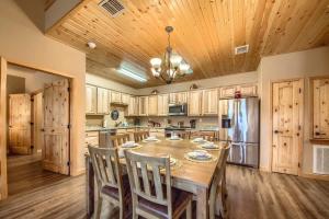 a large kitchen with a table and a refrigerator at OM A14 Gruene Bridge Bungalow at Old Mills Resort in New Braunfels