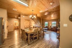 a dining room and living room with a table and chairs at OM A14 Gruene Bridge Bungalow at Old Mills Resort in New Braunfels