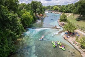 an aerial view of a river with people rafting at OM A14 Gruene Bridge Bungalow at Old Mills Resort in New Braunfels