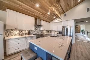 a kitchen with white cabinets and a large island at CL 874 Million Dollar View in Canyon Lake