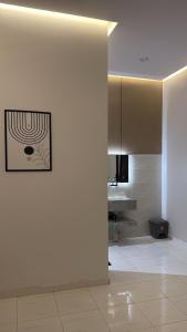a room with a white wall with a picture on it at وحده نجمة الفندقيه2 in Al Qurayyat