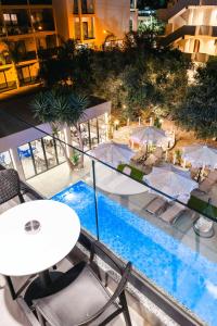 a view of a hotel pool with tables and chairs at Hotel Resol 2 in Ksamil