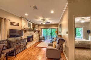 a living room with a couch and a tv and a bed at CW C113 Comal Vista in New Braunfels