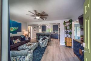 a living room with a couch and a ceiling fan at DT 534 Castle Shadow Cottage in New Braunfels