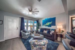 a living room with a couch and chairs and a ceiling fan at DT 534 Castle Shadow Cottage in New Braunfels